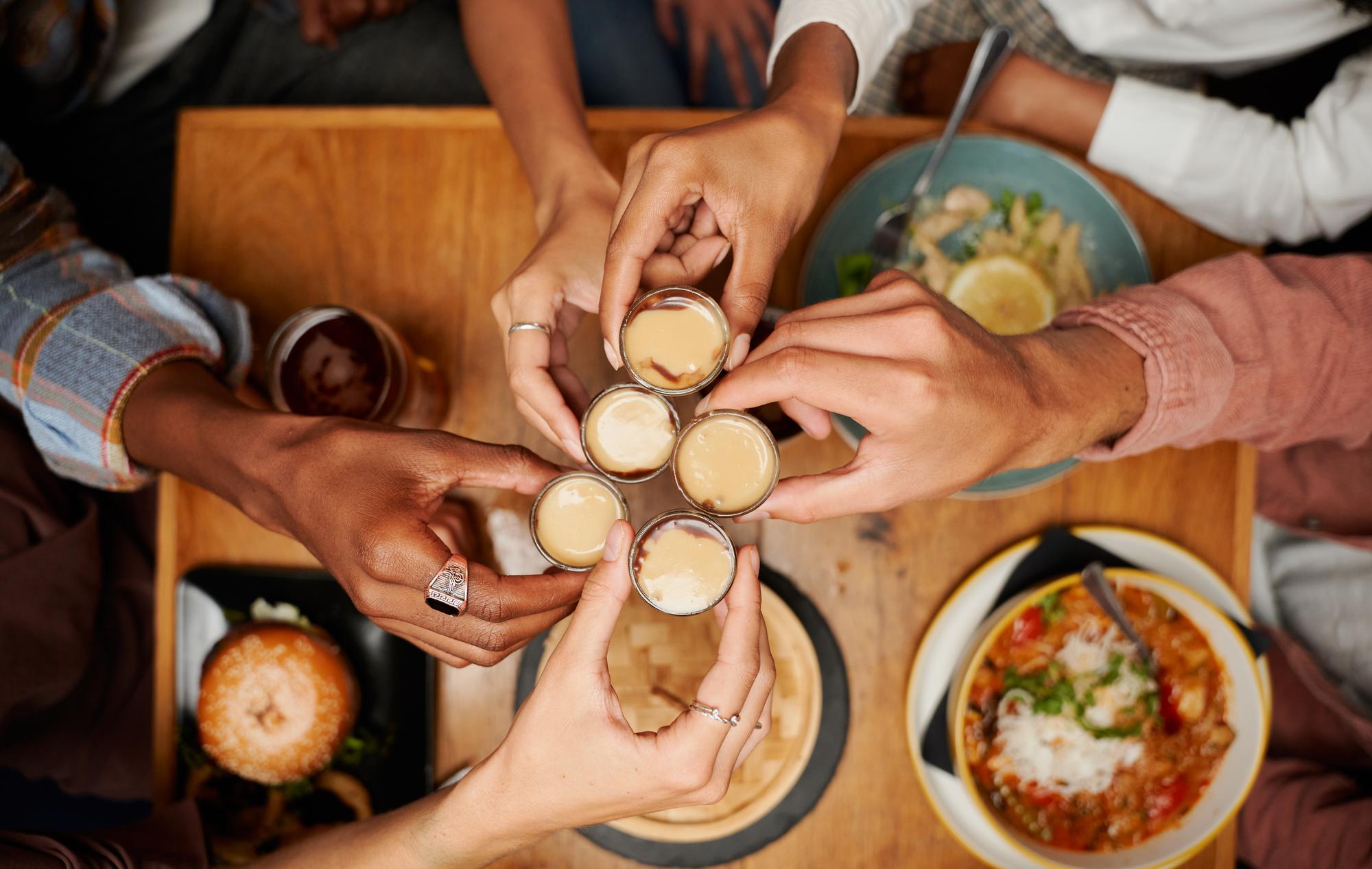 small group around wooden table tasting plates